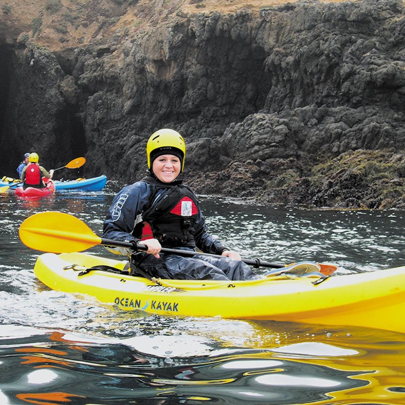 A kayaker wearing a helmet and geared up for cold weather paddles Channel Islands National Park