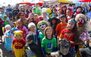 Brightly costumed and festive kids eagerly activities at Farmers' Market Pumpkin Fun Day