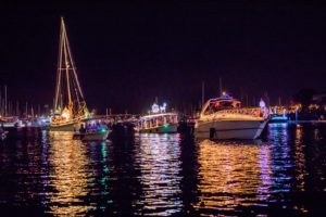 Brightly light and playfully themed boats on Parade in the harbor