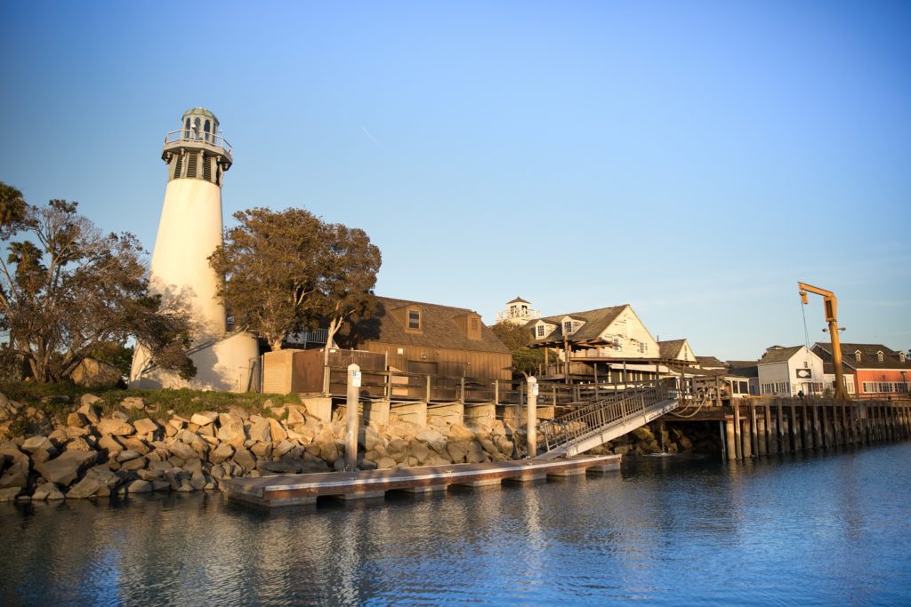 View from the water of the lighthouse, breakwater and crane dock