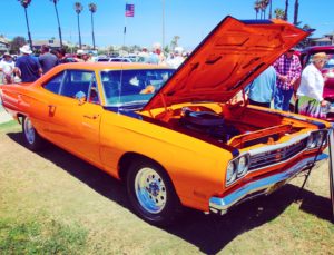 A mint Plymouth Roadrunner with its hood popped at the CIH Father's Day car show
