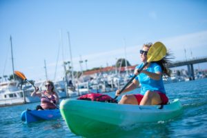 Action shot of a pair of kayak paddlers on the harbor