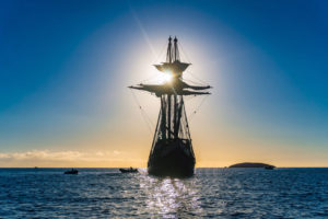 Promotional image of tall-ship the San Salvador, silhouetted by the setting sun