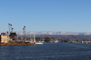 Snow-capped mountains are visible beyond the harbor