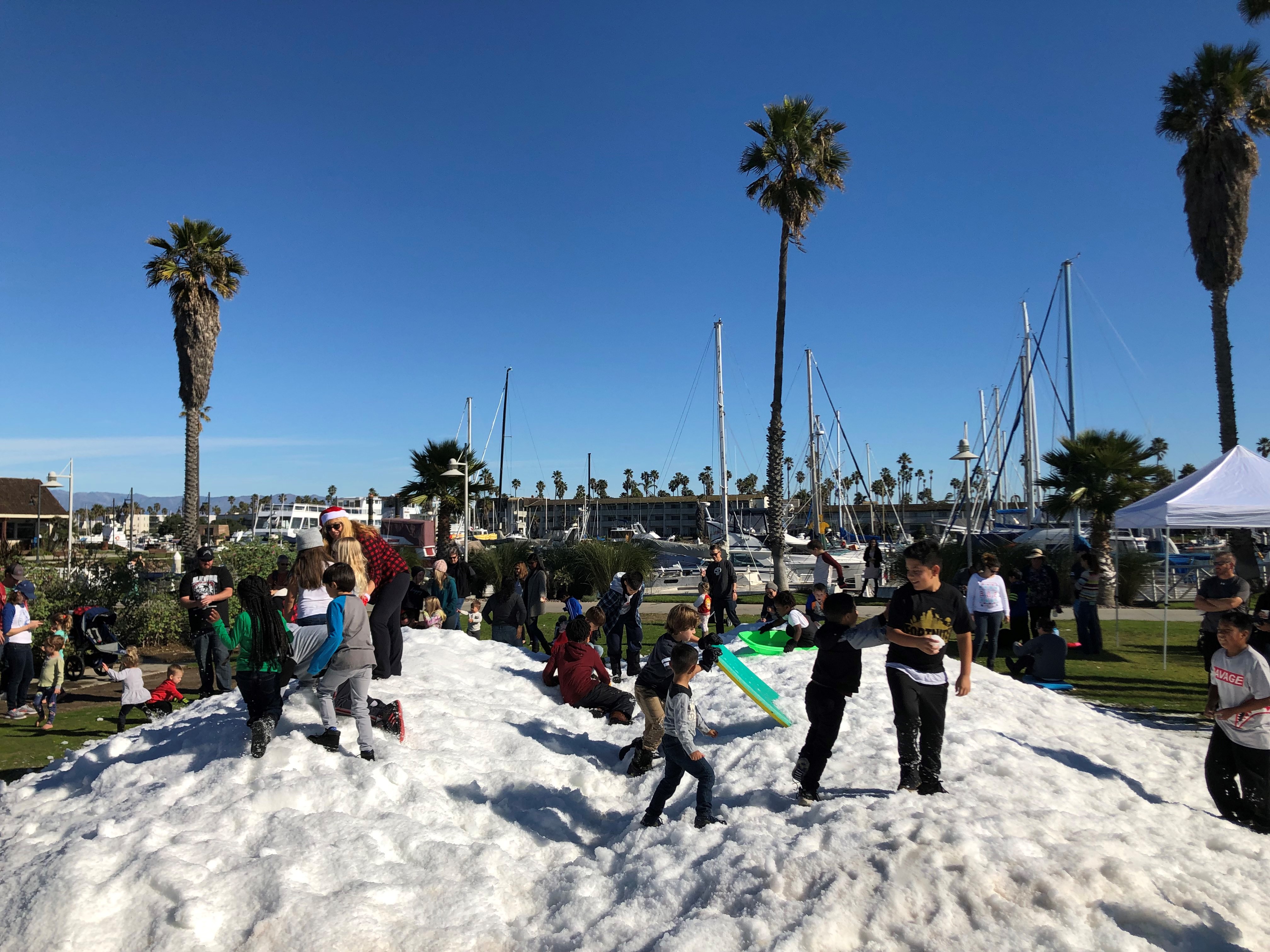 Kids play in snow during the Parade of Lights festival