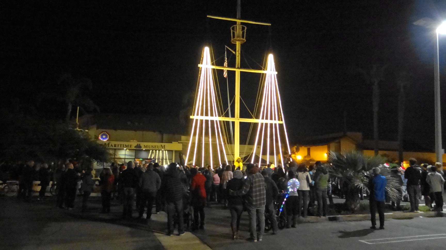 A crowd gathered to watch the 2019 Holiday Lighting of the Tall Ship Mast
