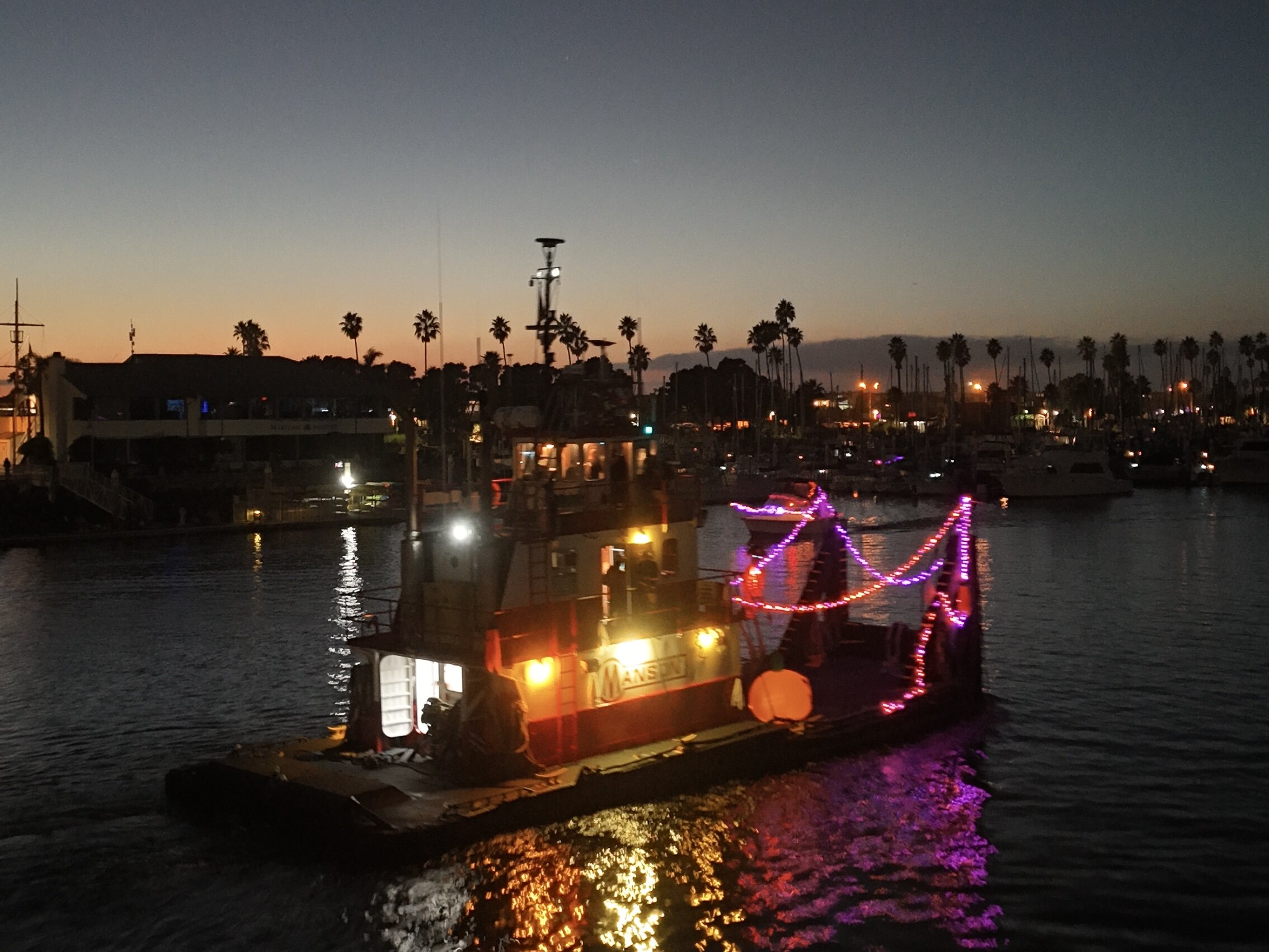 Sunset view of Channel Islands Harbor with illuminated boat during the 5th Annual Parade of Frights.